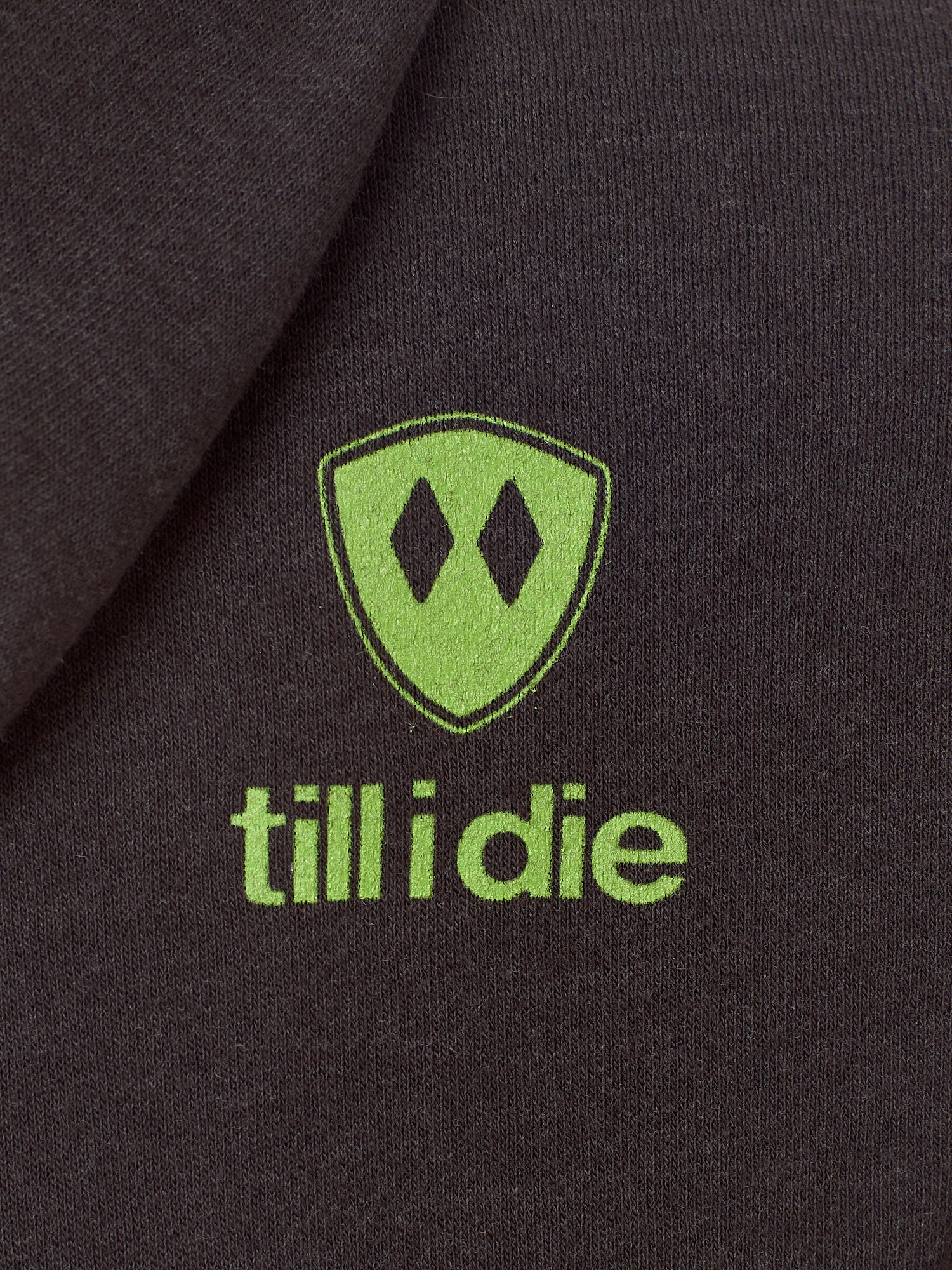 Detail of the lime green till i die logo on a Graphite Black Hoodie