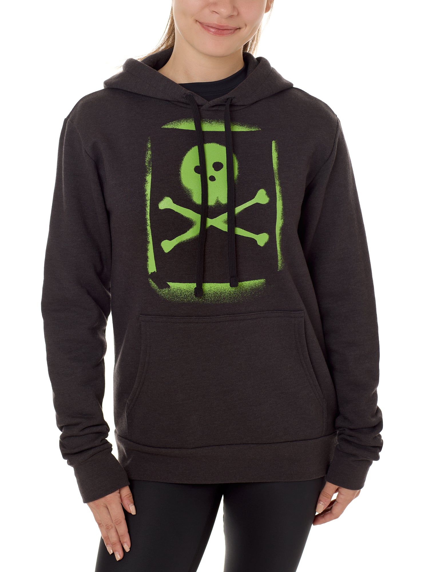 A woman wearing a black hoodie with a green skull and crossbones graphic on the front.