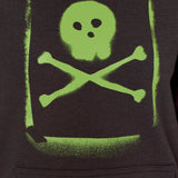 Detail of the Graffiti hoodie in Black, featuring a lime green spray painted style design of a skull and crossbones with overspray accents