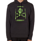 A male model wearing a black hoodie with a bold, green skull and crossbones design on the front.