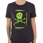 A woman wearing a black crew neck t-shirt with a green spray-painted skull and crossbones graphic on the front.