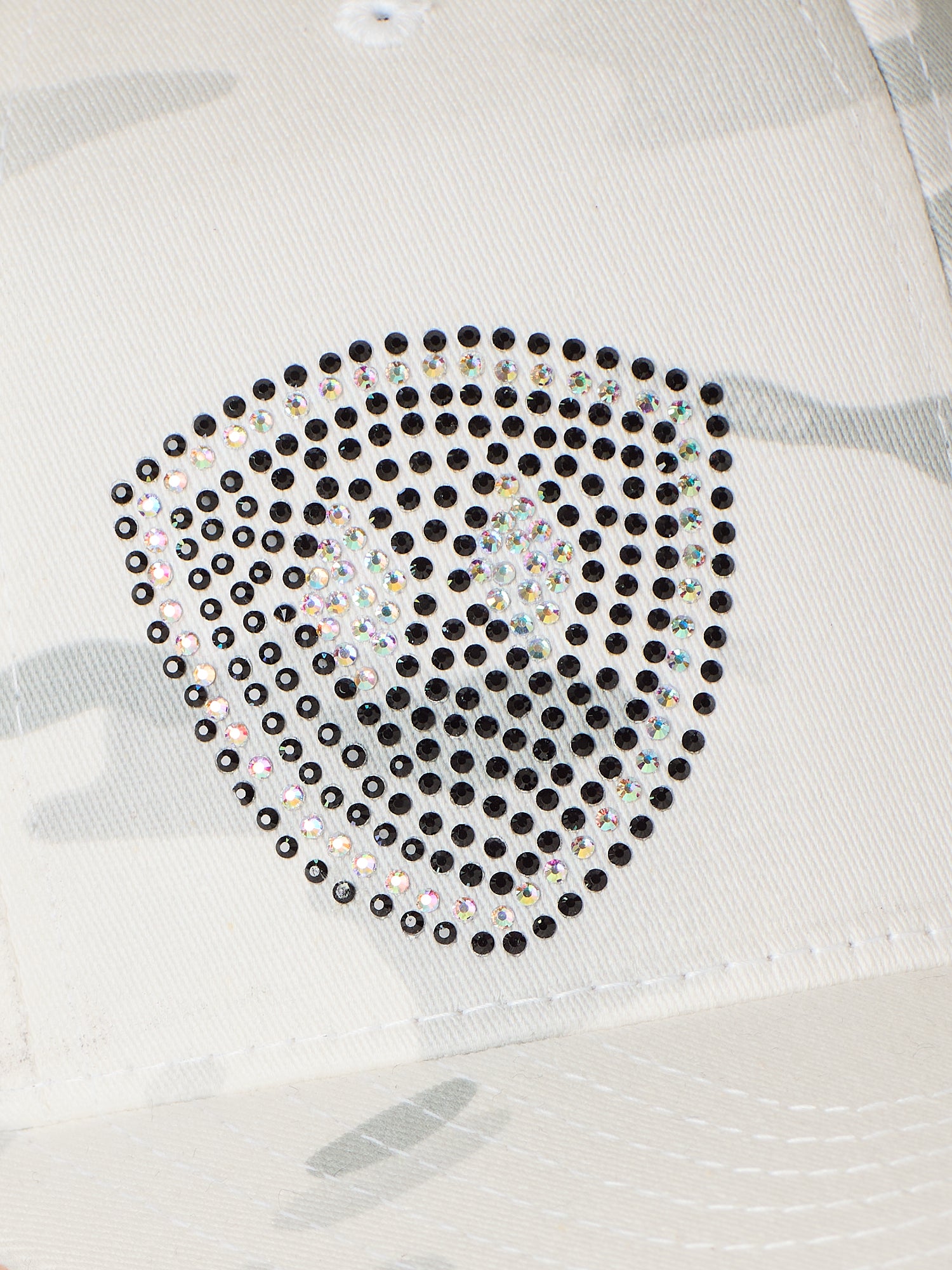 Close Up detail of a Rhinestone Embellished double diamond shield on an alpine white camouflage base