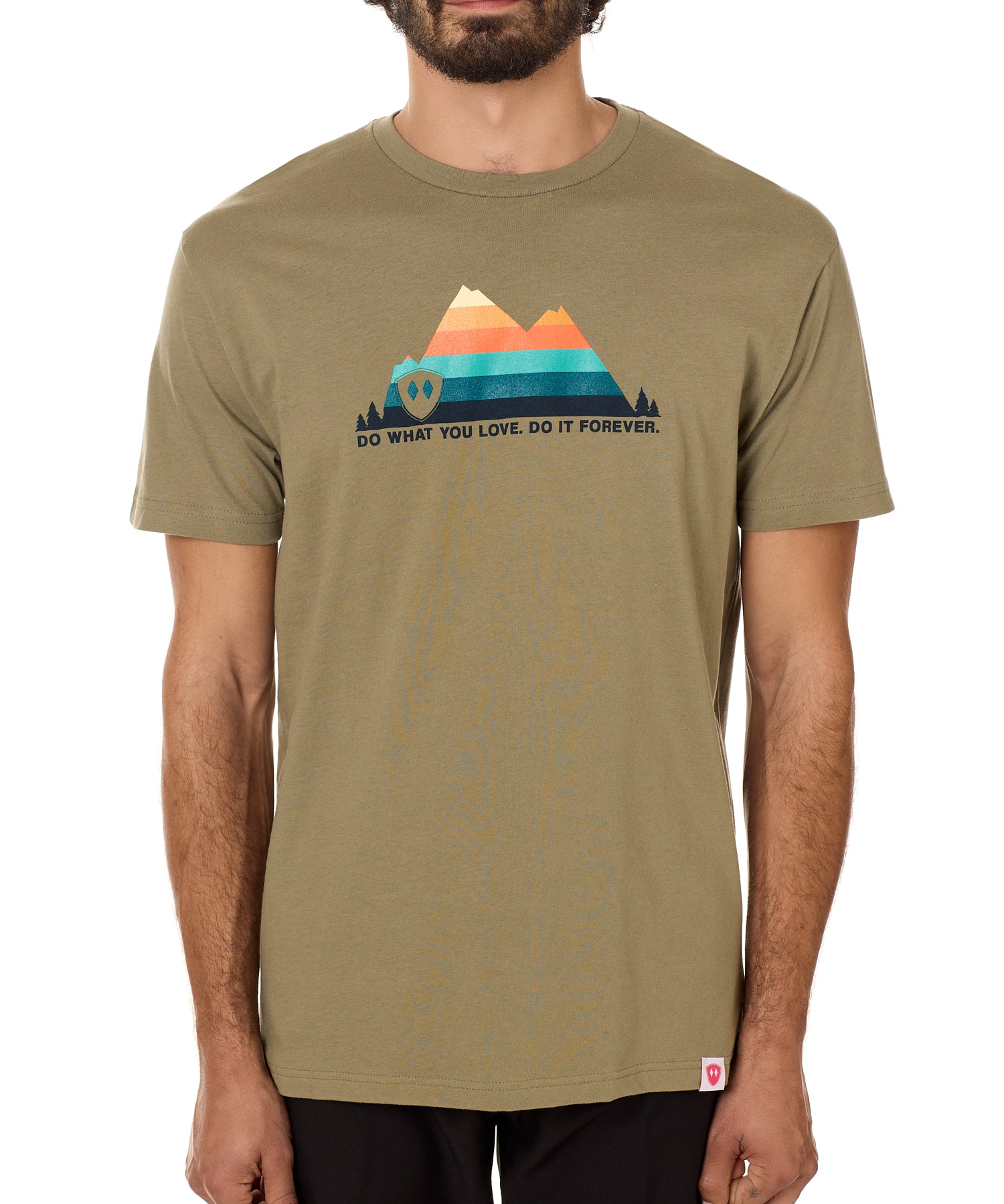 A male model wearing a green crew neck t-shirt with a mountain and sunset design and 'DO WHAT YOU LOVE. DO IT FORVER.' TEXT