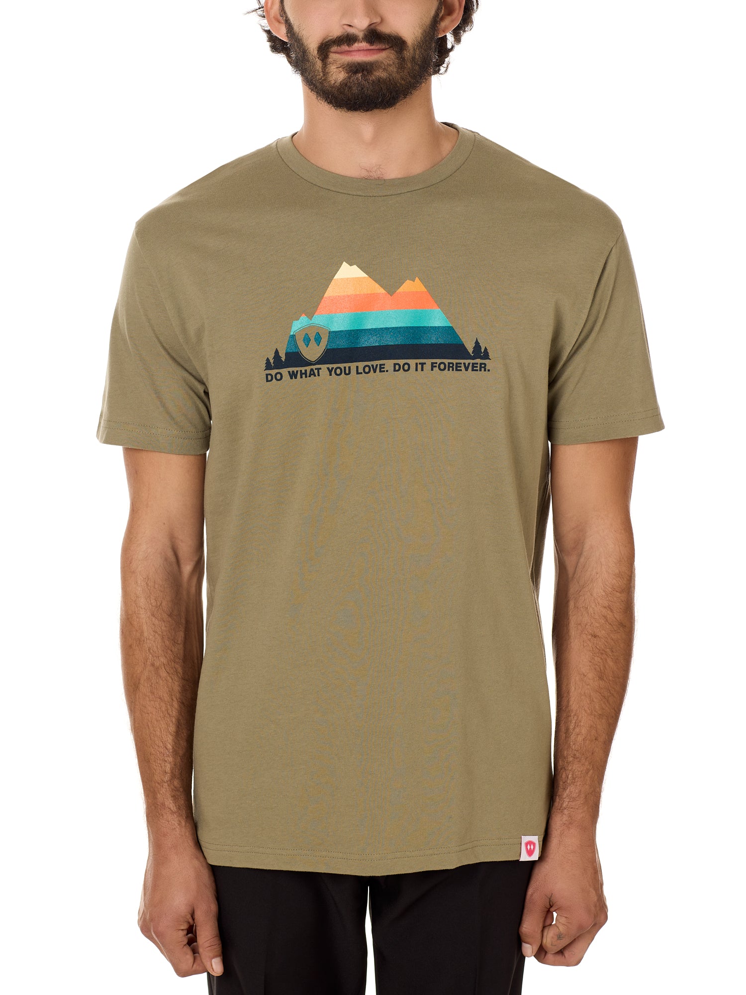 A male model wearing a green crew neck t-shirt with a mountain and sunset design and 'DO WHAT YOU LOVE. DO IT FORVER.' TEXT