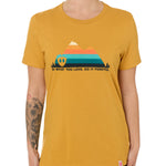 A female model wearing a mustard crew neck t-shirt with a mountain and sunset design and 'DO WHAT YOU LOVE. DO IT FORVER.' TEXT