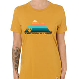 A female model wearing a mustard crew neck t-shirt with a mountain and sunset design and 'DO WHAT YOU LOVE. DO IT FORVER.' TEXT