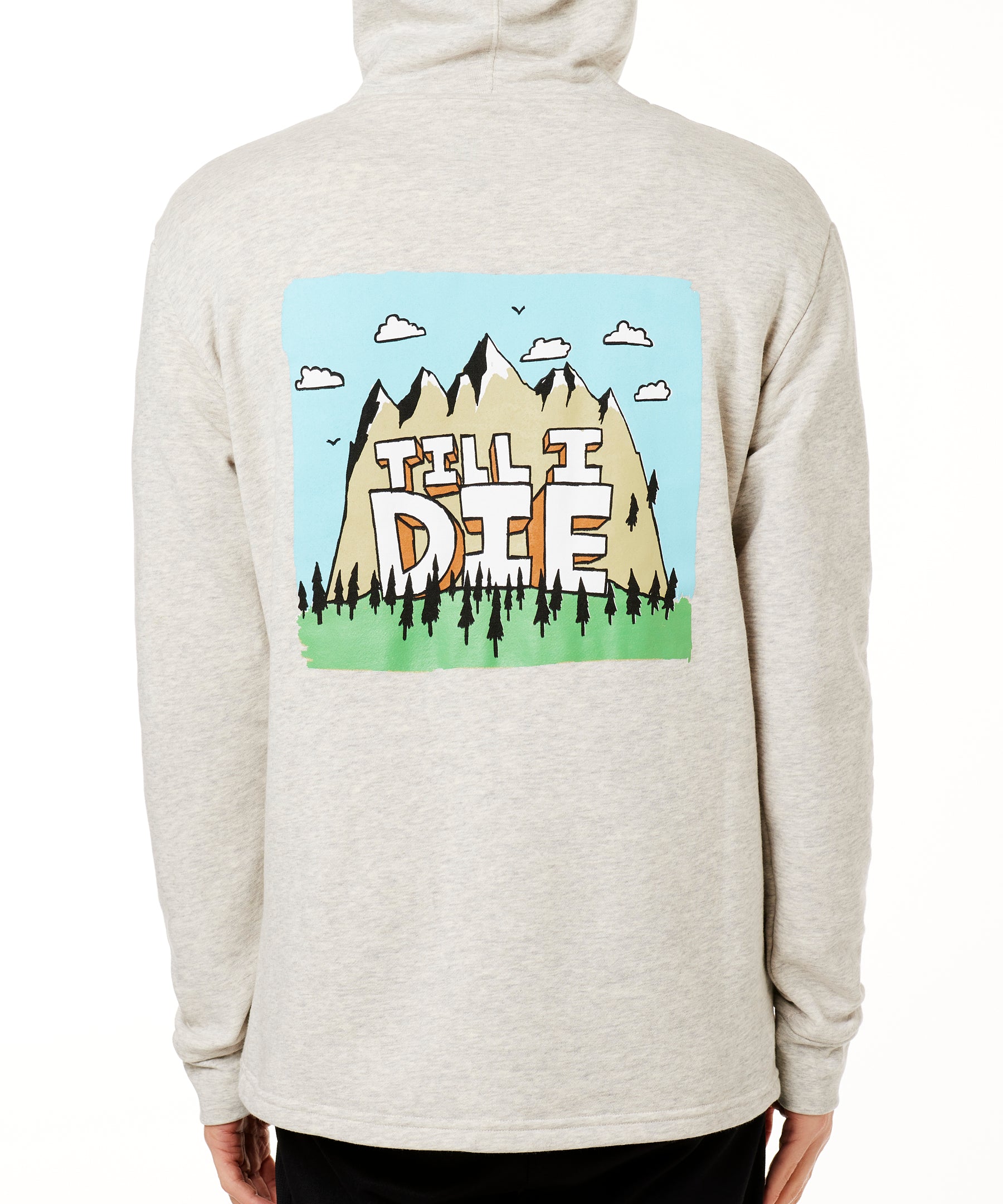 MALE MODEL WEARING A HEATHER OATMEAL HOODIE WITH HOOD UP, FEATURING A GRAPHIC OF A CARTOON MOUNTAIN THAT HAS TILL I DIE ACROSS IT
