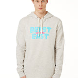 FEMALE MODEL WEARING A HEATHER OATMEAL HOODIE WITH A PINK AND BLUE GRAHIC THAT SAYS BEAST OF THE EAST