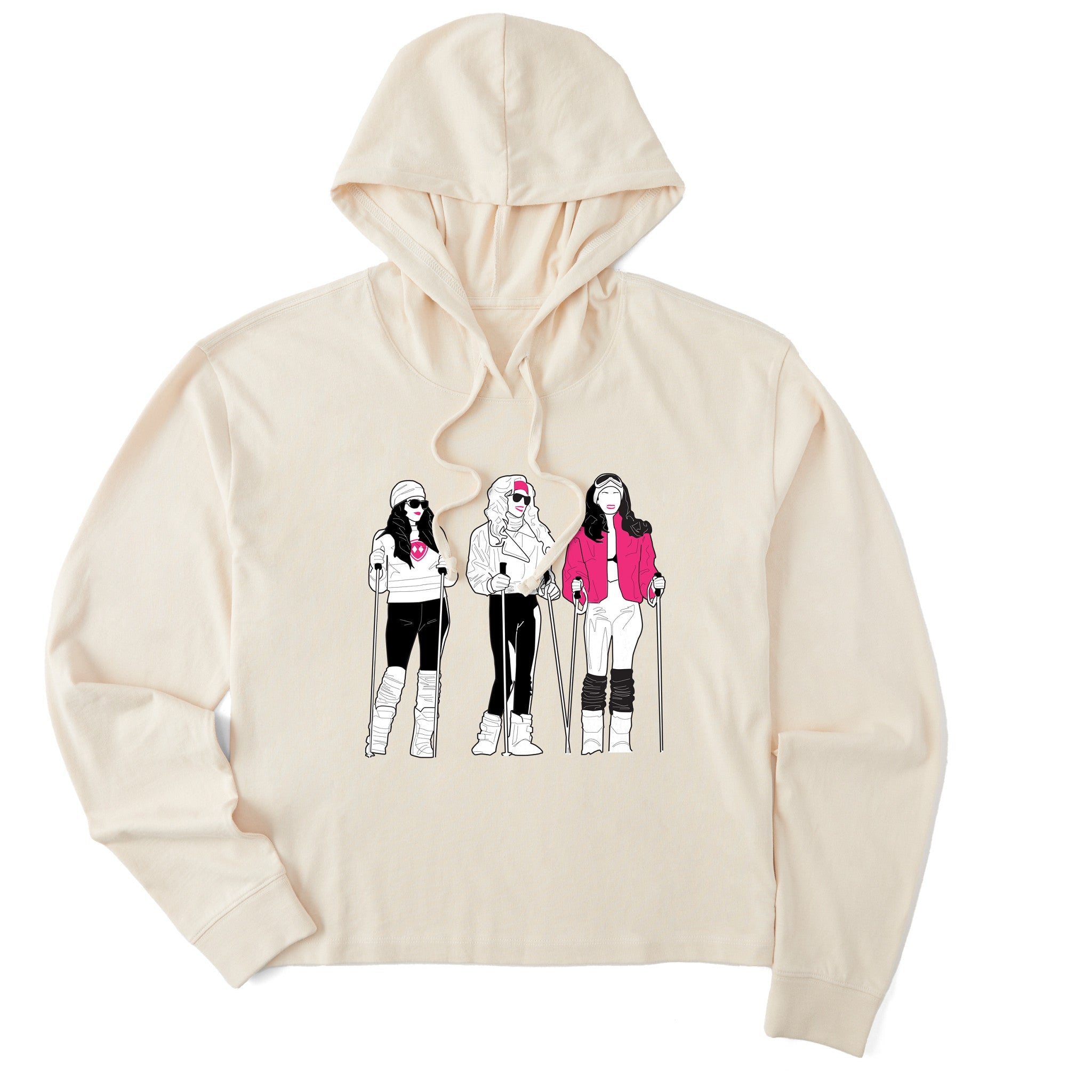 Cream women’s cropped hoodie featuring an illustrated trio of female skiers dressed in retro 1980s ski fashion, rendered in black and white with bold hot pink accents.