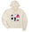 Cream women’s cropped hoodie featuring an illustrated trio of female skiers dressed in retro 1980s ski fashion, rendered in black and white with bold hot pink accents.