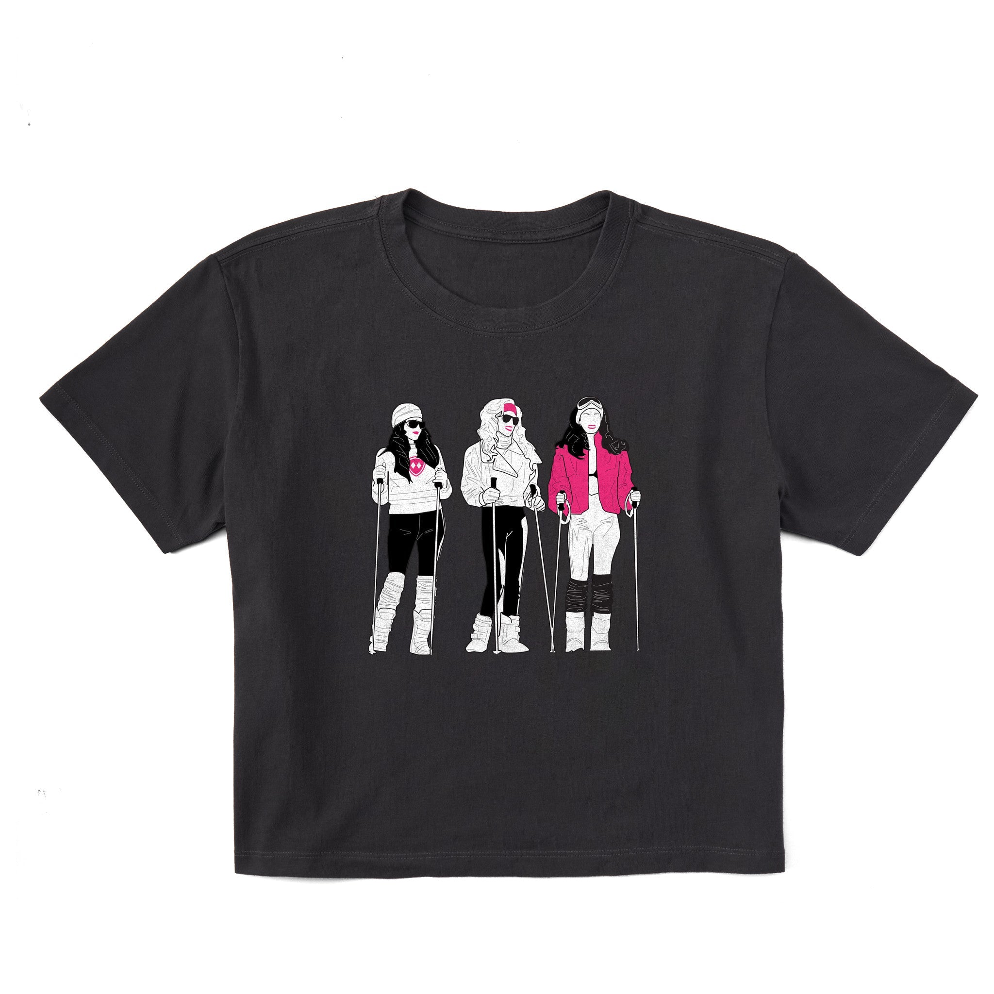 Black women’s cropped T-shirt featuring an illustrated trio of female skiers dressed in retro 1980s ski fashion, rendered in black and white with bold hot pink accents.