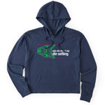 Navy crop hoodie featuring a neon green technical illustration of a ski binding with hot pink accents and a DIN setting cranked to 11, alongside bold white text reading, “Ask me about my DIN setting.”