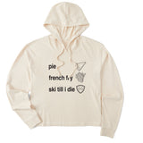Cream cropped hoodie featuring black text and hand-drawn icons celebrating three mountain essentials: pie, French fries, and “Ski Till I Die,” finished with the signature Double Diamond shield.