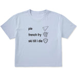 Light blue cropped T-shirt featuring black text and hand-drawn icons celebrating three mountain essentials: pie, French fries, and “Ski Till I Die,” finished with the signature Double Diamond shield.