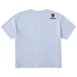 A light blue crop tee shirt shown from the back, featuring the double diamond shield logo and the text 'till i die' on the upper right shoulder, set against a plain white background.