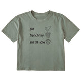 Sage green cropped T-shirt featuring black text and hand-drawn icons celebrating three mountain essentials: pie, French fries, and “Ski Till I Die,” finished with the signature Double Diamond shield.