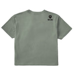 A sage green crop tee shirt shown from the back, featuring the double diamond shield logo and the text 'till i die' on the upper right shoulder, set against a plain white background.