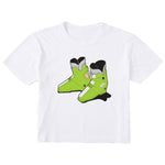A white short-sleeve crewneck t-shirt featuring a graphic print of a pair of bright lime green rear entry ski boots with black and white details on the front.