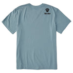 A light blue crewneck t-shirt shown from the back, featuring a double diamond shield and the brand name 'till i die' printed on the upper right back.