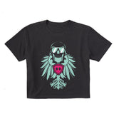 Faded black cropped short sleeve T-shirt featuring a bold teal winged skull wearing sunglasses, finished with a bright pink Double Diamond shield at the center.
