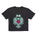 Faded black cropped short sleeve T-shirt featuring a bold teal winged skull wearing sunglasses, finished with a bright pink Double Diamond shield at the center.