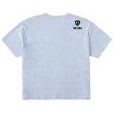 A light blue cropped tee shirt shown from the back, featuring the double diamond shield logo and the text 'till i die' on the upper right shoulder, set against a plain white background.