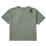 A military green cropped tee shirt shown from the back, featuring the double diamond shield logo and the text 'till i die' on the upper right shoulder, set against a plain white background.