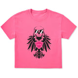 Bright pink cropped short sleeve T-shirt featuring a bold black winged skull wearing sunglasses, finished with a bright pink Double Diamond shield at the center.