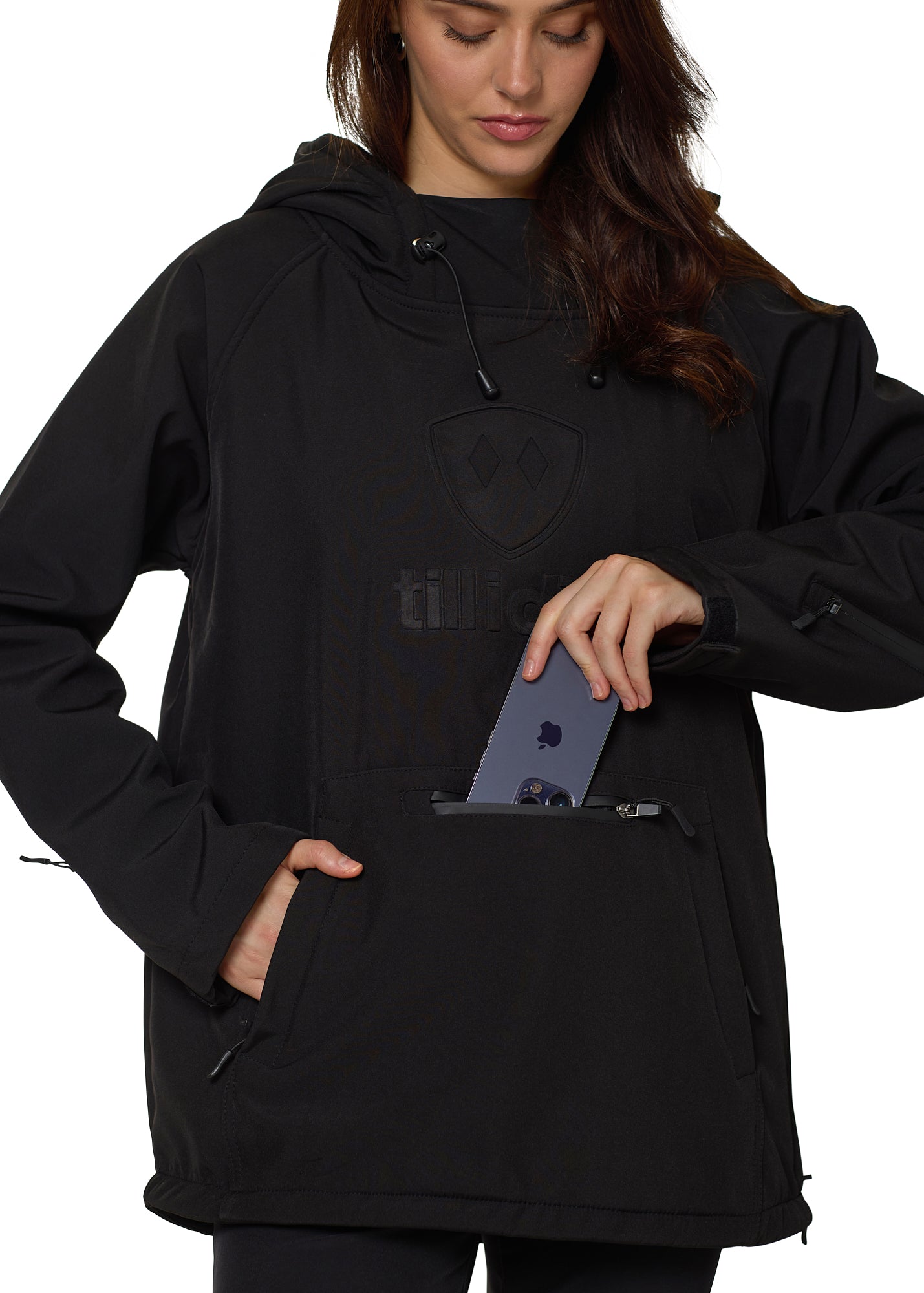 Model placing smartphone into front waterproof zipper pocket of Till I Die black pullover.