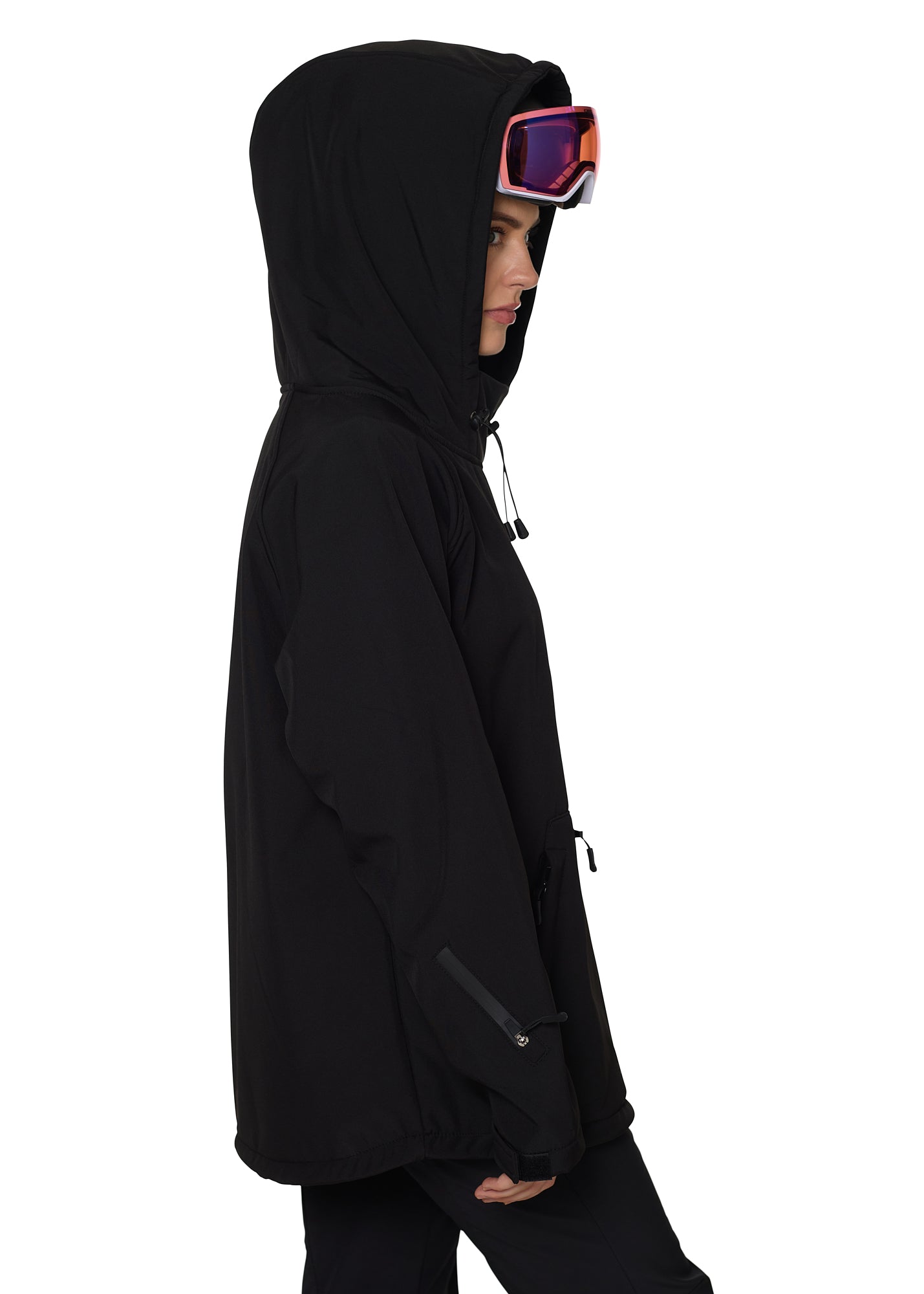 Profile view of hooded black pullover with helmet and ski goggles, highlighting ergonomic silhouette.