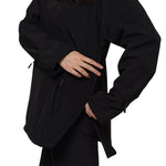 Model adjusting side zipper on black softshell pullover jacket