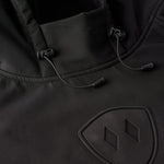 Close-up of helmet-compatible hood and drawcords on black performance pullover