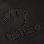 Close-up of embossed double diamond shield and Till I Die logo on chest