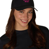 Female model wearing Apr�s Till I Die hat, smiling in a studio setting