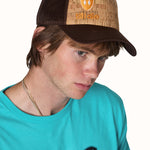 male model wearing a brown cork trucker hat with an orange embroidered till i die logo