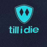 Close-up of Till I Die blue logo and double diamond shield on back of navy long sleeve shirt