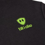 Detail of lime green trail sign graphic on Till I Die "I'm Hard" hoodie, Winter 2025