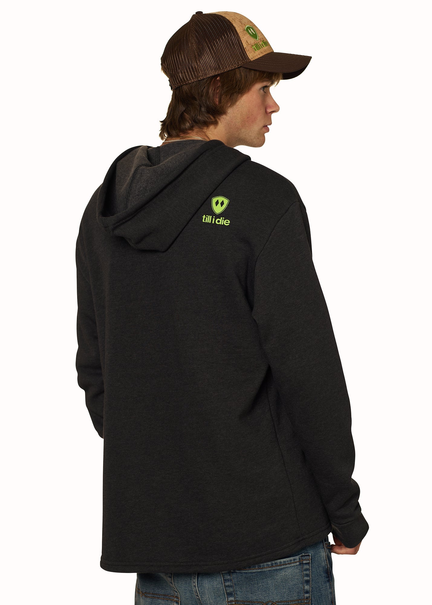 Back view of male model in Till I Die "I'm Hard" hoodie with Logo Cork Trucker hat, Winter 2025
