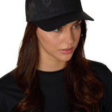 Female model wearing the Till I Die Black-on-Black Trucker Hat, captured at a slight angle to highlight the tonal embroidery.