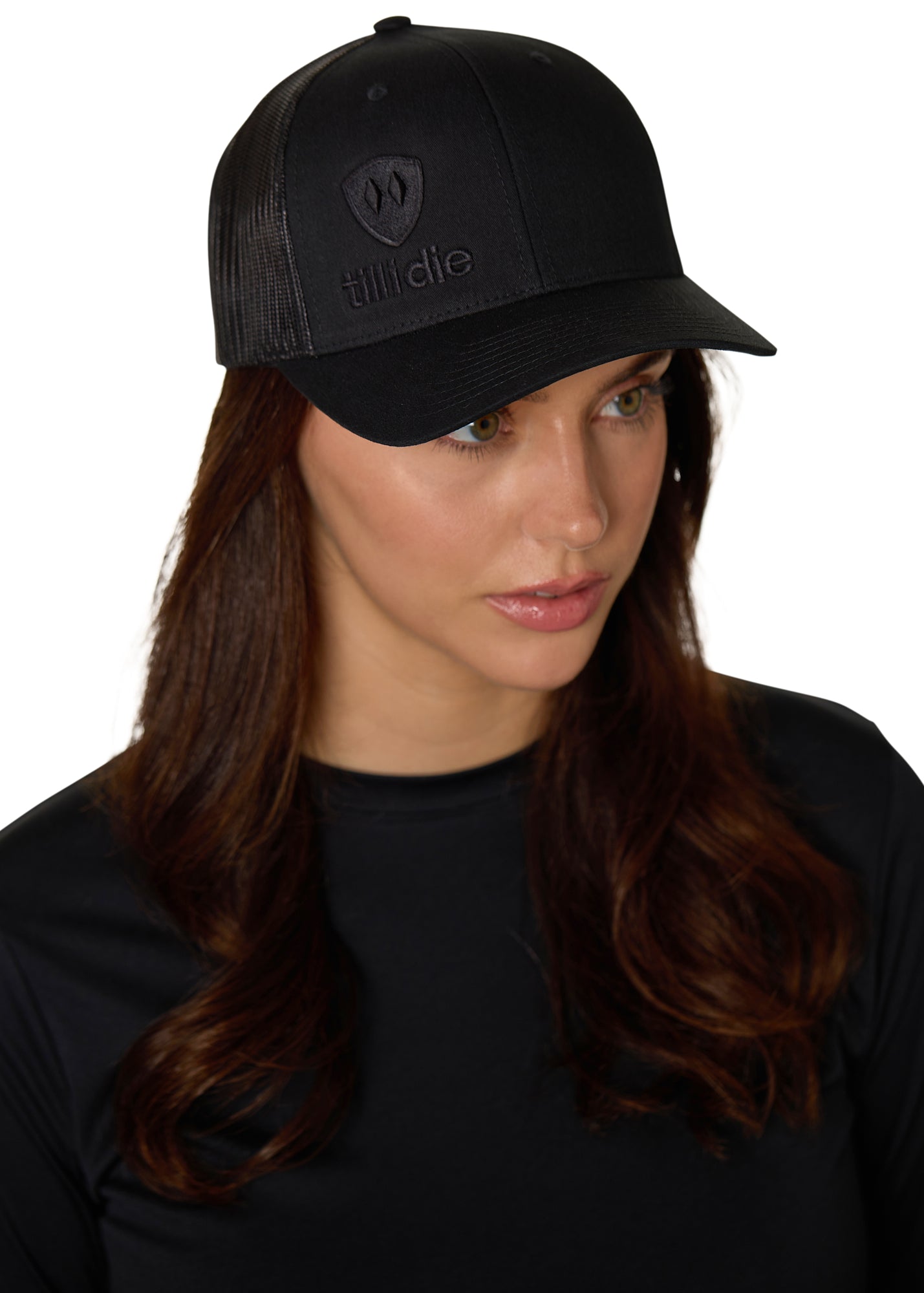 Female model wearing the Till I Die Black-on-Black Trucker Hat, captured at a slight angle to highlight the tonal embroidery.