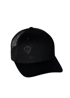Flat lay of the Till I Die Black-on-Black Trucker Hat, showcasing the stacked logo and Double Diamond Shield in puff embroidery.