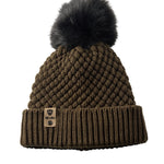 Product flat lay of the Diamond Knit Pom Beanie in military olive, displaying the ribbed cuff, diamond knit design, and leather logo tab with faux fur pom.