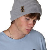 Male model wearing the Till I Die Leather Tab Knit Beanie in cadet blue, showcasing the cozy fit and branded leather detail on the cuff