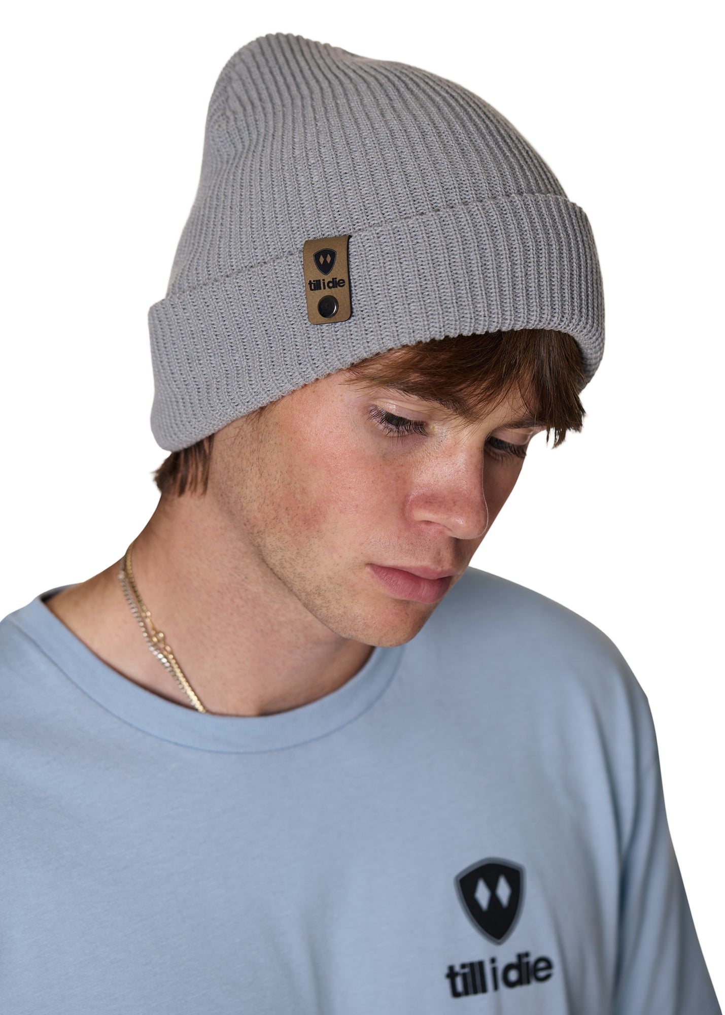 Male model wearing the Till I Die Leather Tab Knit Beanie in cadet blue, showcasing the cozy fit and branded leather detail on the cuff