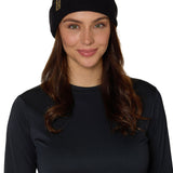 Female model wearing the Till I Die Leather Tab Knit Beanie in black, showcasing the cozy fit and branded leather detail on the cuff