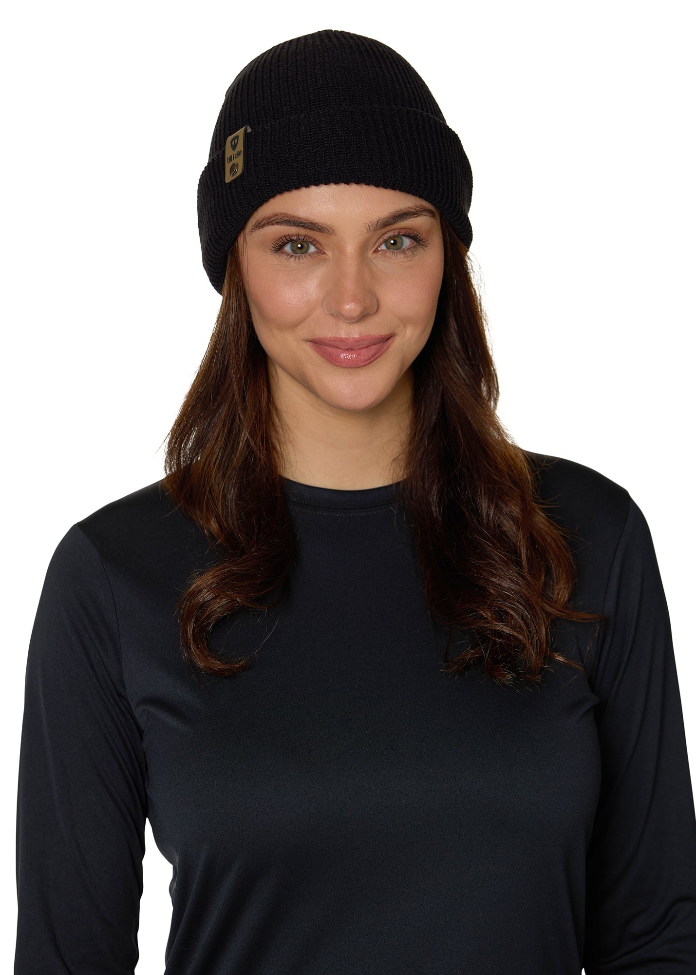 Female model wearing the Till I Die Leather Tab Knit Beanie in black, showcasing the cozy fit and branded leather detail on the cuff