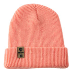 Flat lay of the Till I Die coral knit beanie showing  the medium gauge knit and branded leather logo tab on the cuff