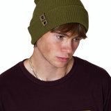 Male model wearing the Till I Die Leather Tab Knit Beanie in military green, styled with the cuff folded to show the branded leather logo tab