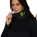 Female model wearing the Till I Die Logo Neck Gaiter in Lime, shown covering her neck as she holds it up toward her face.