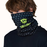 Male model wearing the Till I Die Logo Neck Gaiter in Lime, with the gaiter pulled up to cover his nose and neck.